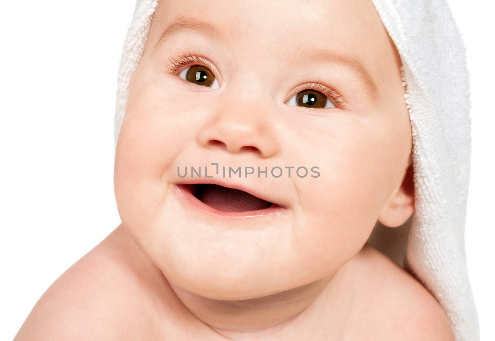 Smiling child with a towel on his head. Isolated on white