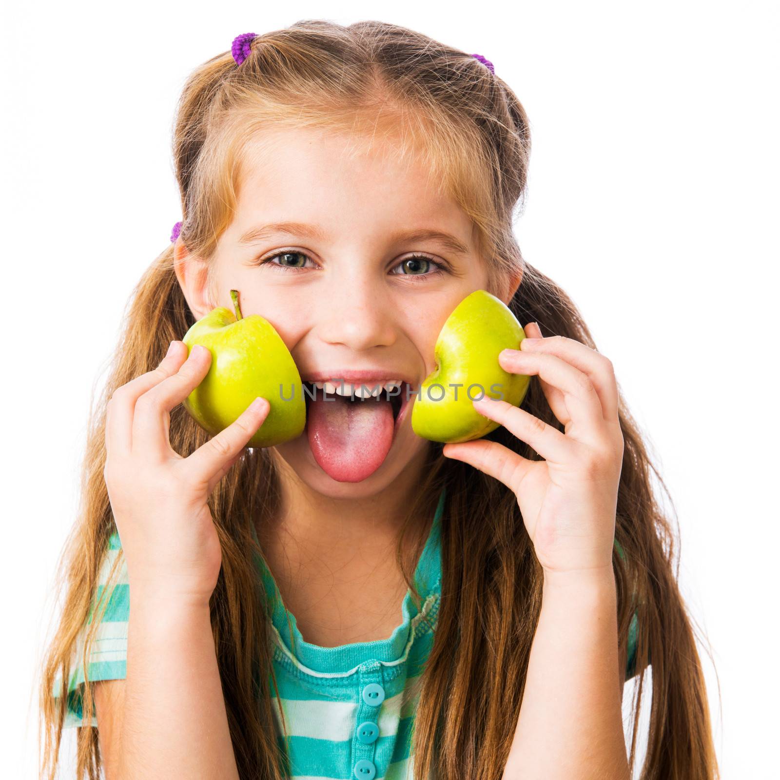 little girl with two halves of an apple isolated on white background