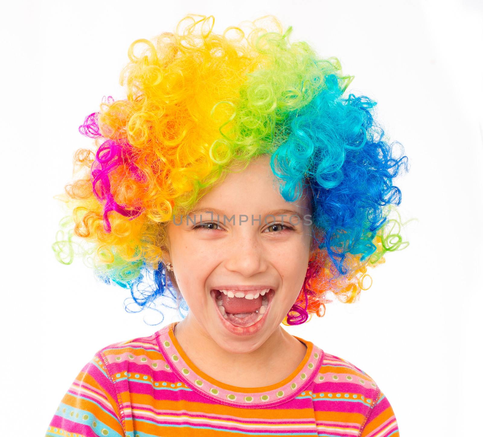 smiling little girl in clown wig isolated on white background