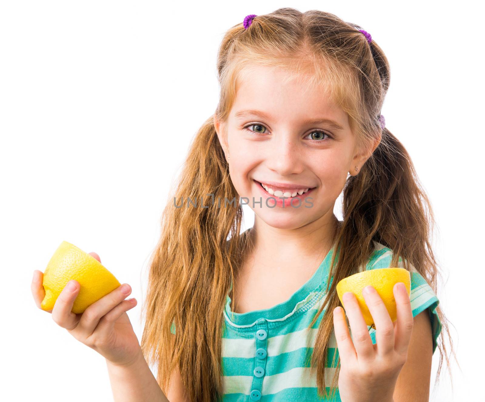 little girl with two halves of a lemon isolated on a white background