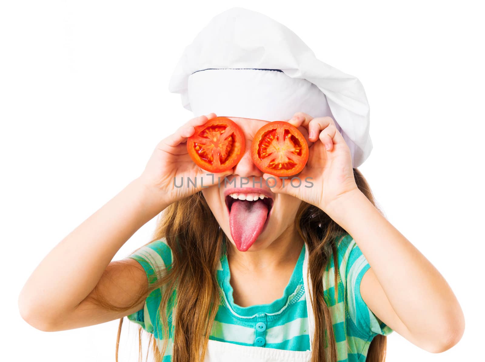 little girl in chef hat with tomatoes near the eye shows tongue