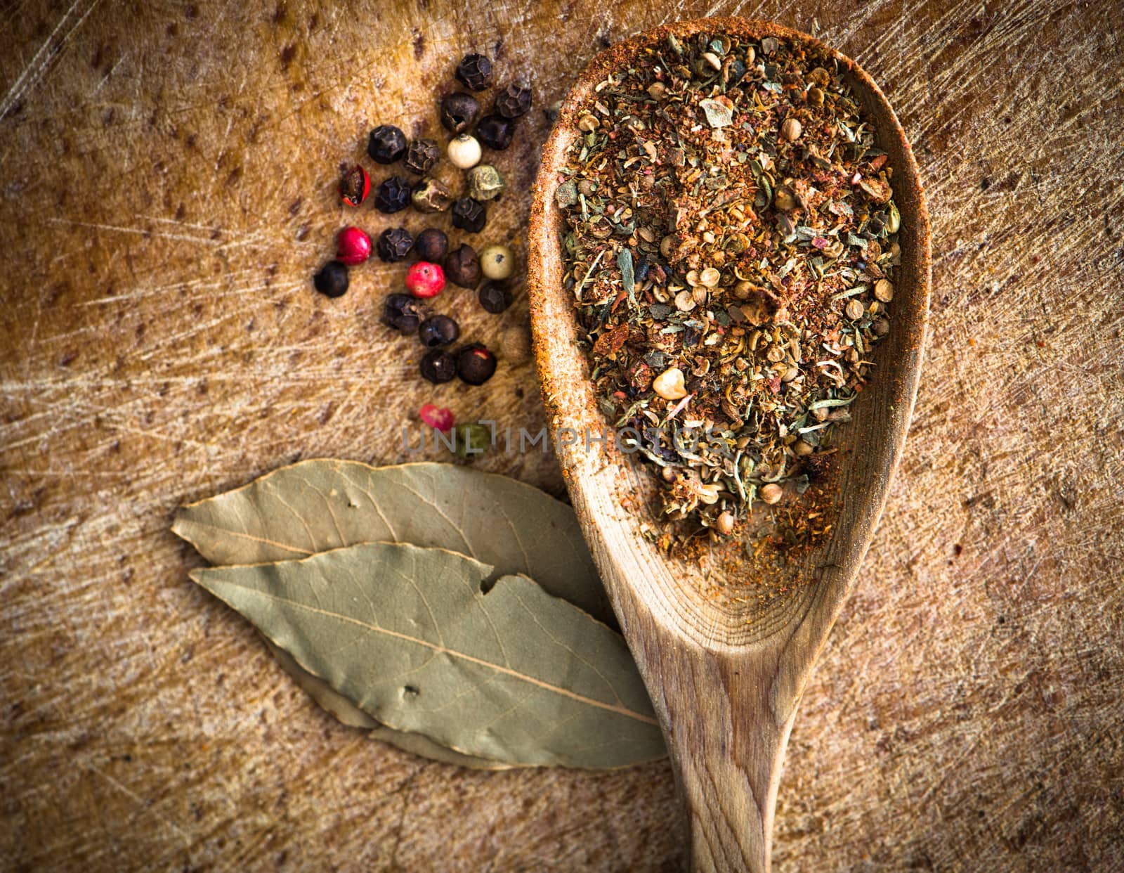 spices in a wooden spoon on a cutting board