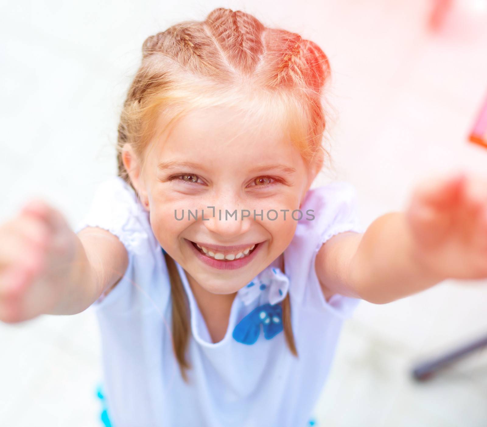 cute little girl smiling in a park close-up