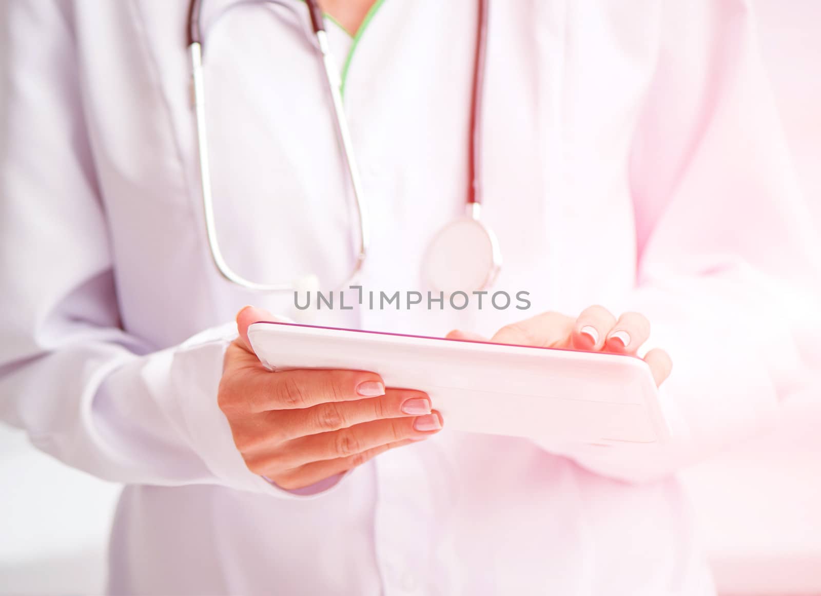 Doctor using a white digital tablet