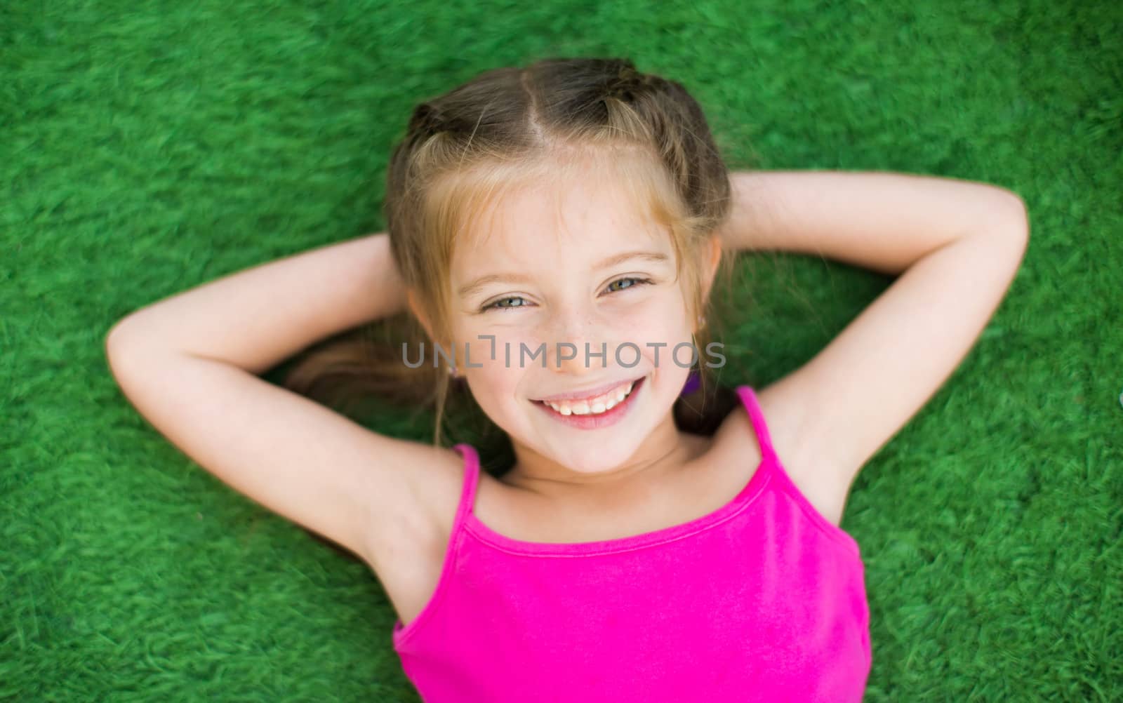 Little girl on green grass by GekaSkr