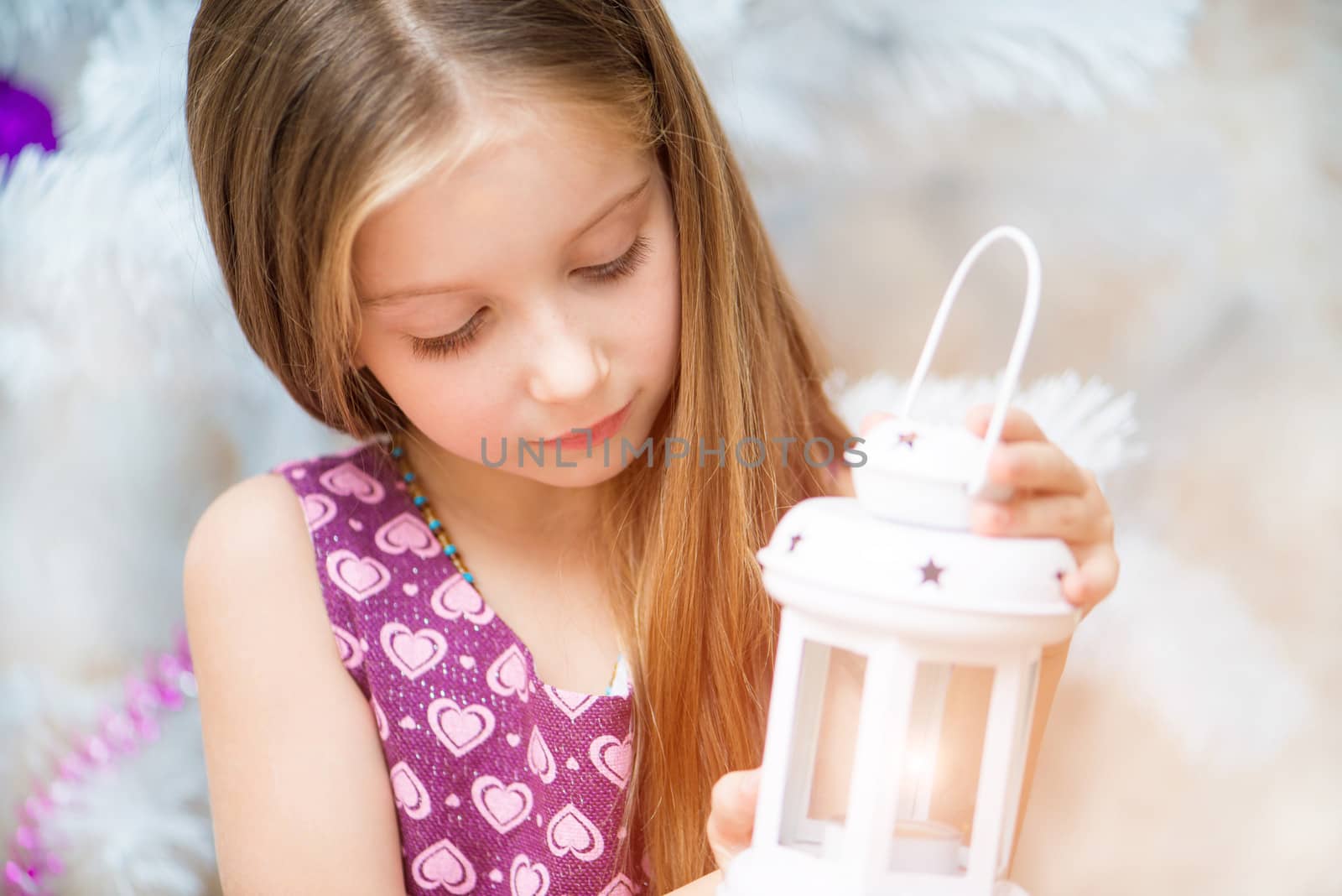 beautiful little girl holding a lantern