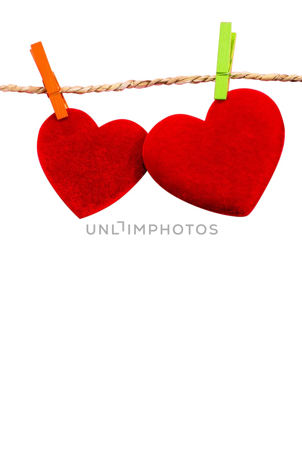 Cute big red heart hanging on the clothesline. On white  background