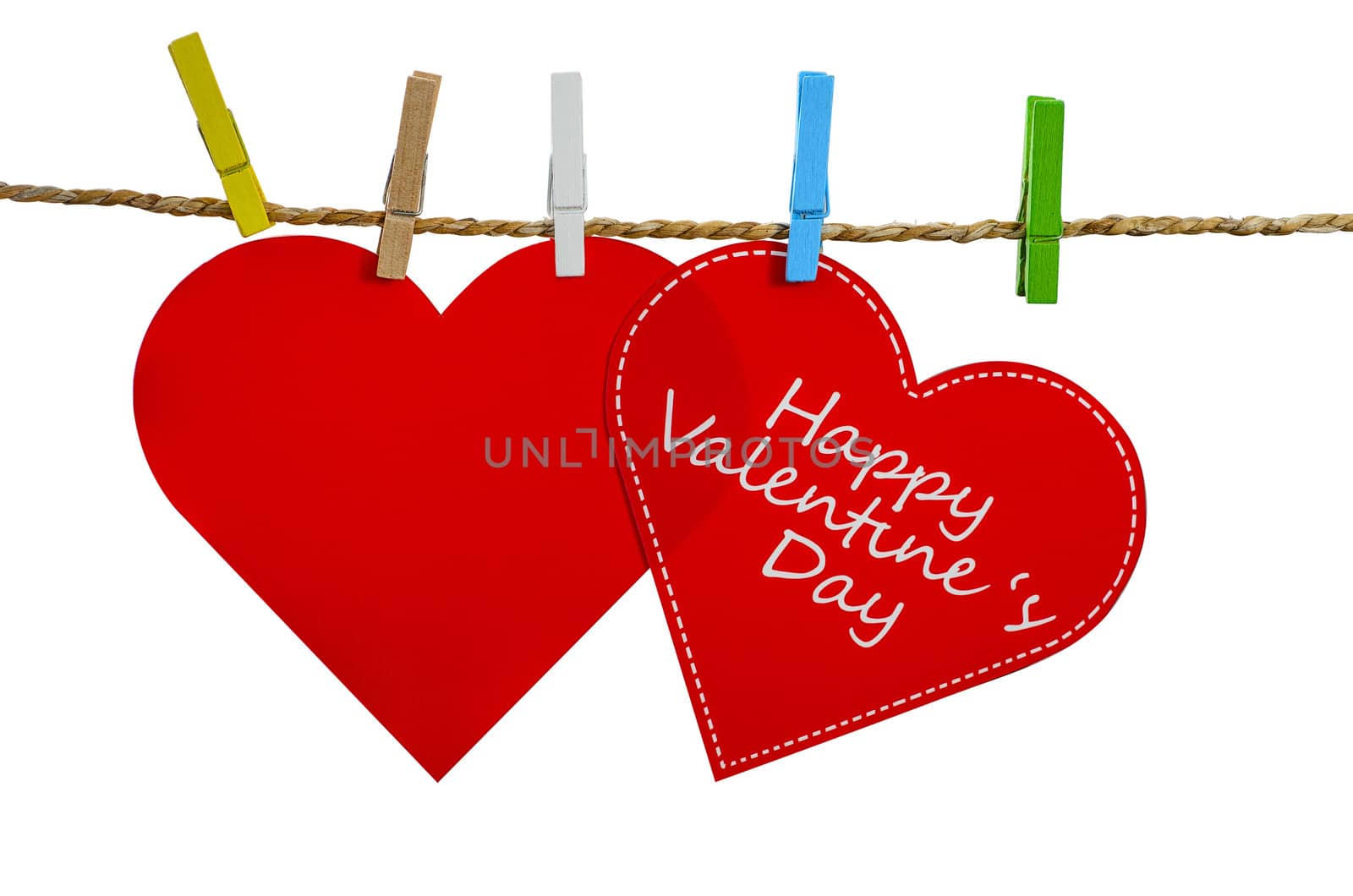 Cute big red heart hanging on the clothesline. On white  background