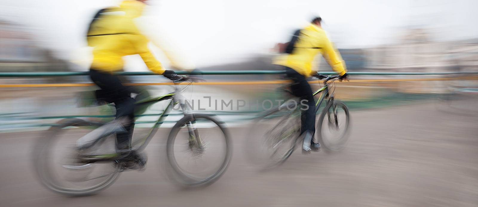 Abstract image of two cyclists on the city roadway. Intentional motion blur