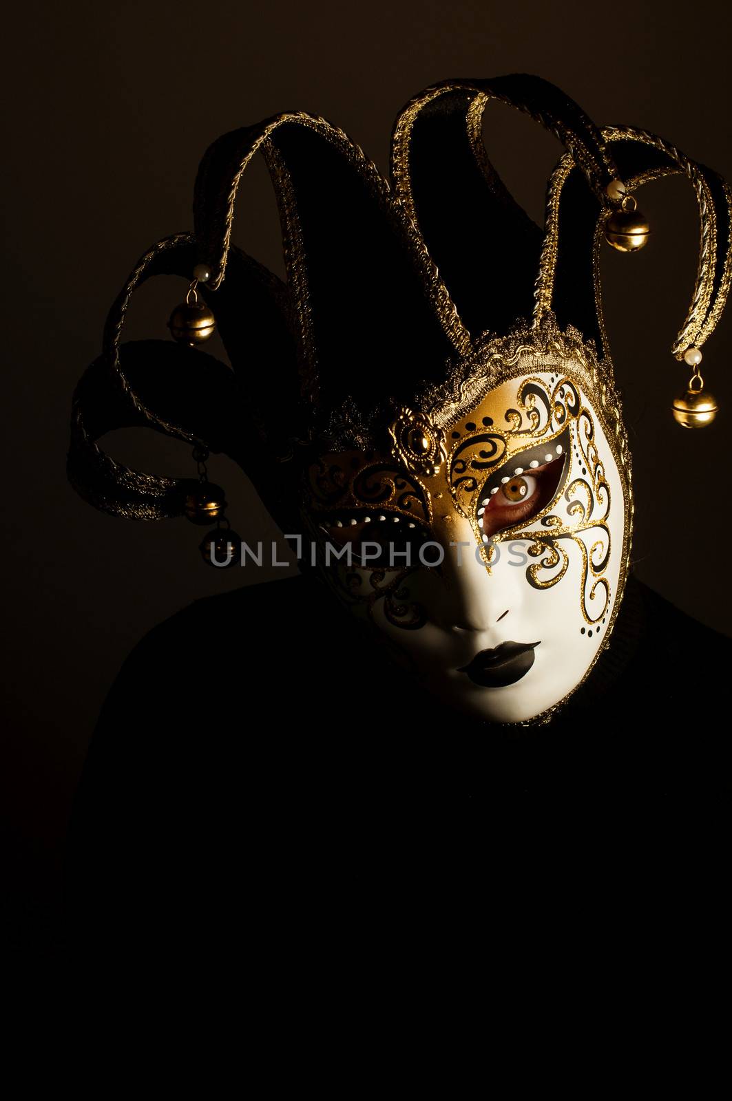 a portrait with Jester mask on black background