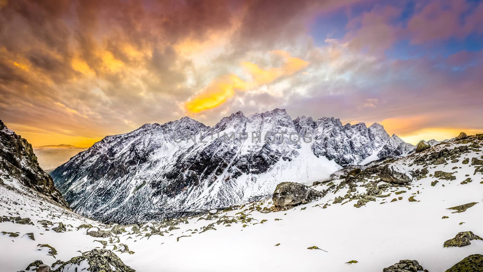 Panoramic view of white winter mountains after colorful sunset, High Tatras, Slovakia