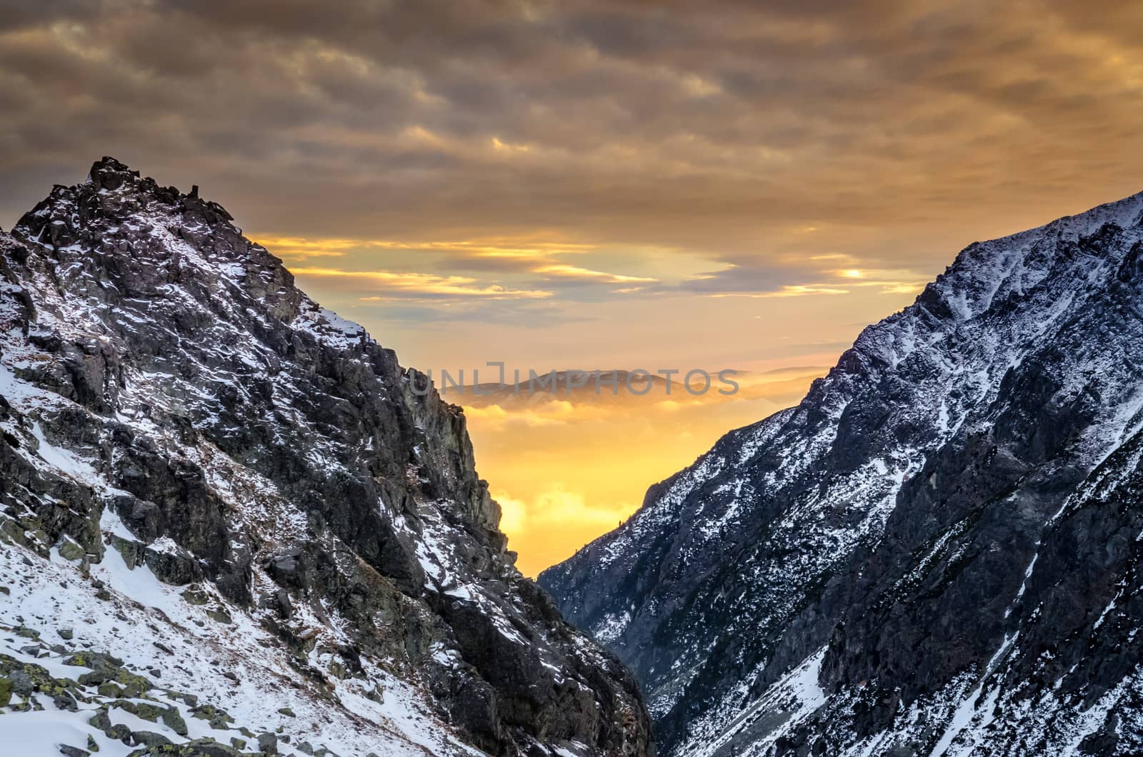 Winter mountains at sunset with colorful clouds and sky, High Tatras, Slovakia