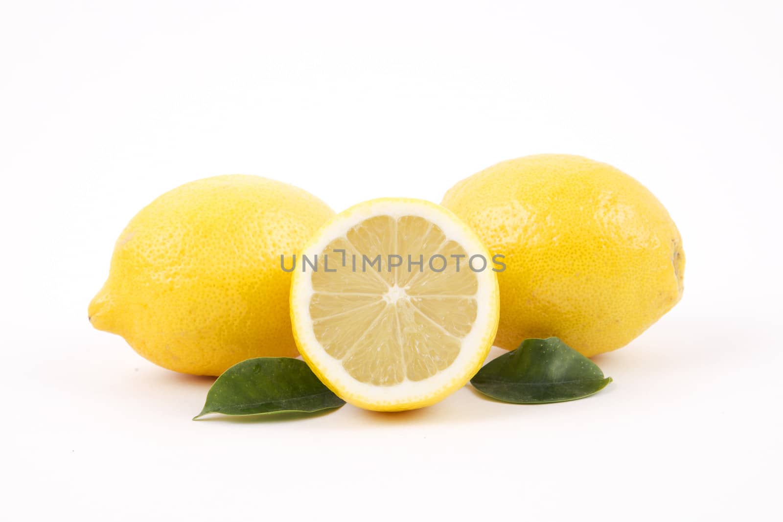 Fresh lemons with slice on a white background.