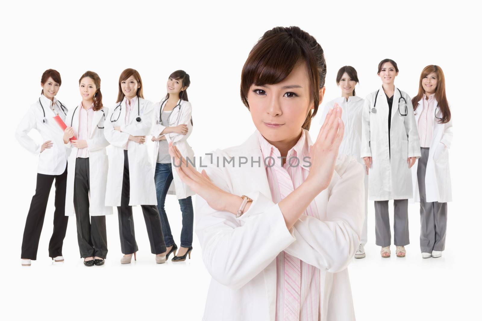 Asian doctor woman stand in front of her team and give you a stop sign, closeup portrait on white background.