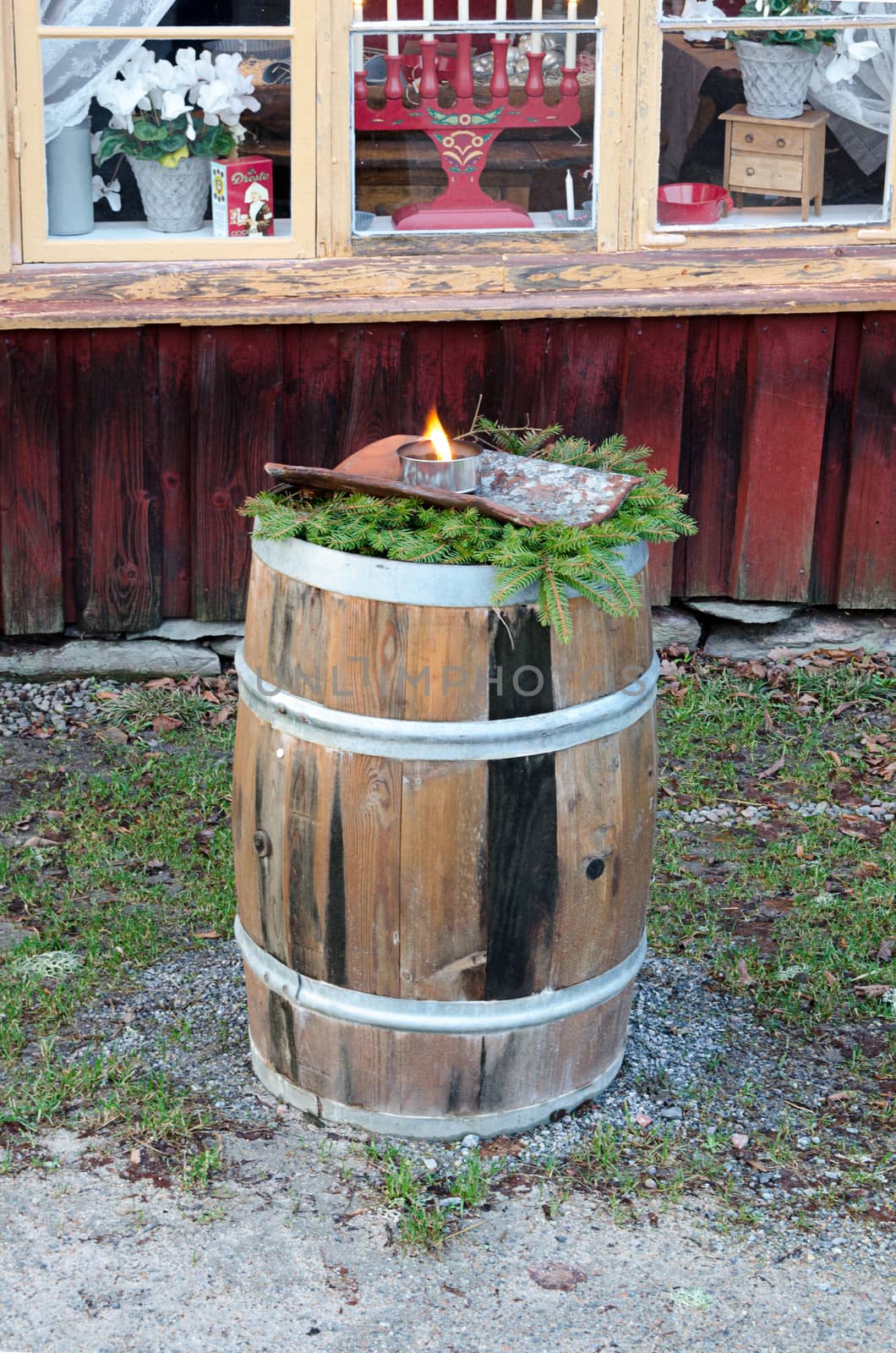an old wooden barrel with burning torches at Christmas