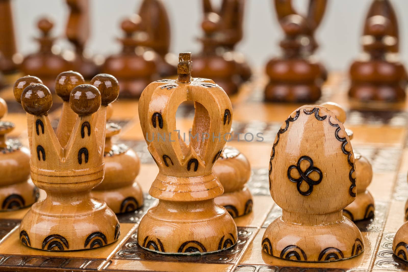 closeup chess board focus to white king and queen on white background