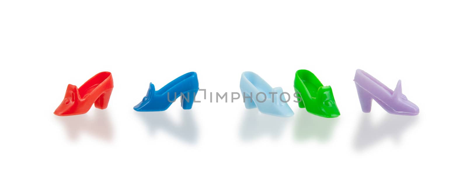 Small plastic toy shoes isolated on white background