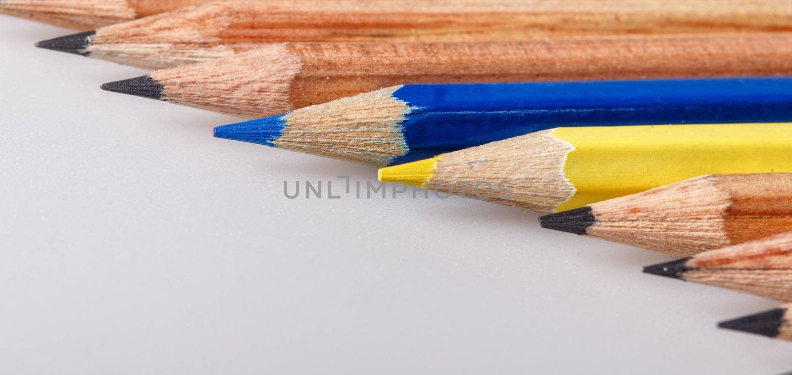 Color pencil stands out against a series of graphite pencils