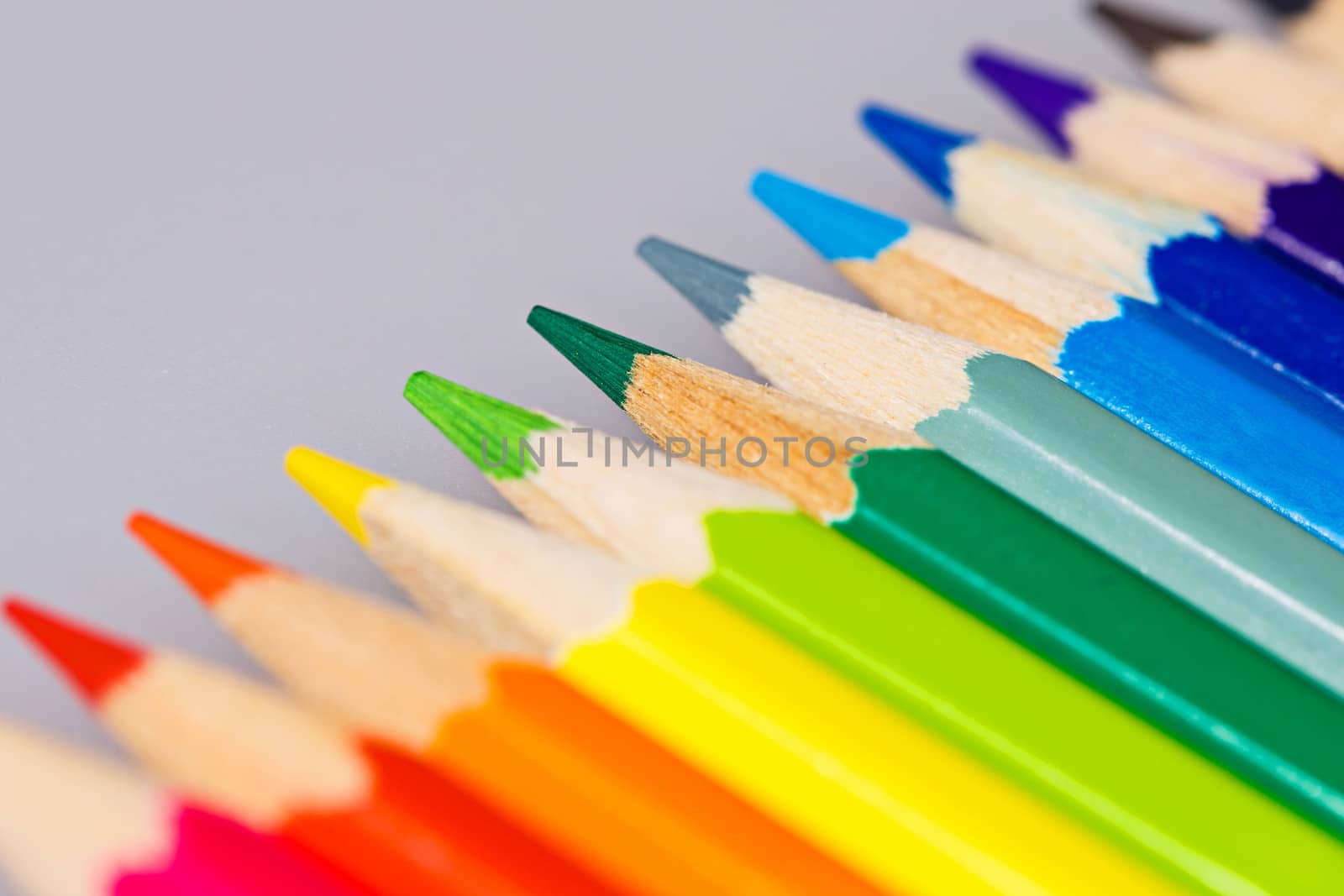 Brightly colored wooden pencils closeup shot background