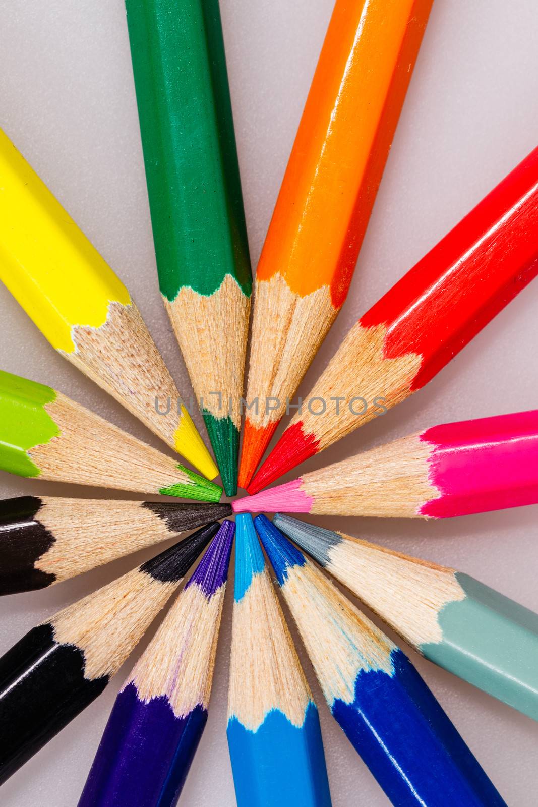 Brightly colored wooden pencils closeup shot background