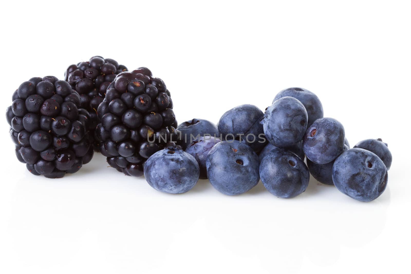 Macro of blackberries and currant berries over white background