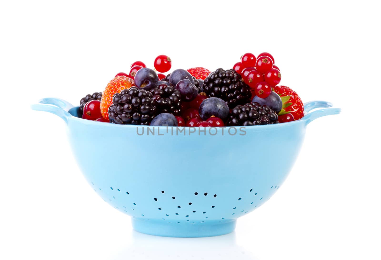 Blue colander with healthy fresh fruit over white background