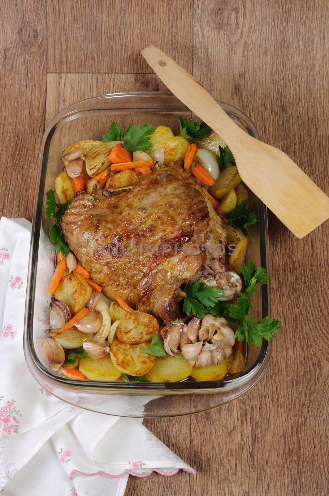 Turkey thigh baked with vegetables in a pan
