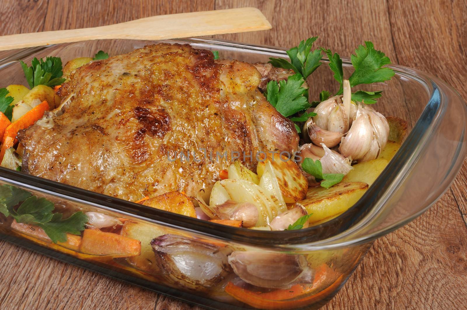 Turkey thigh baked with vegetables in a pan
