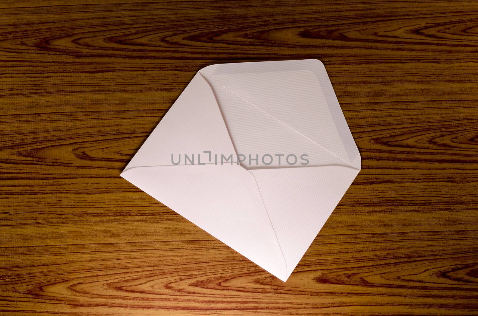 soft pink envelope on wooden background
