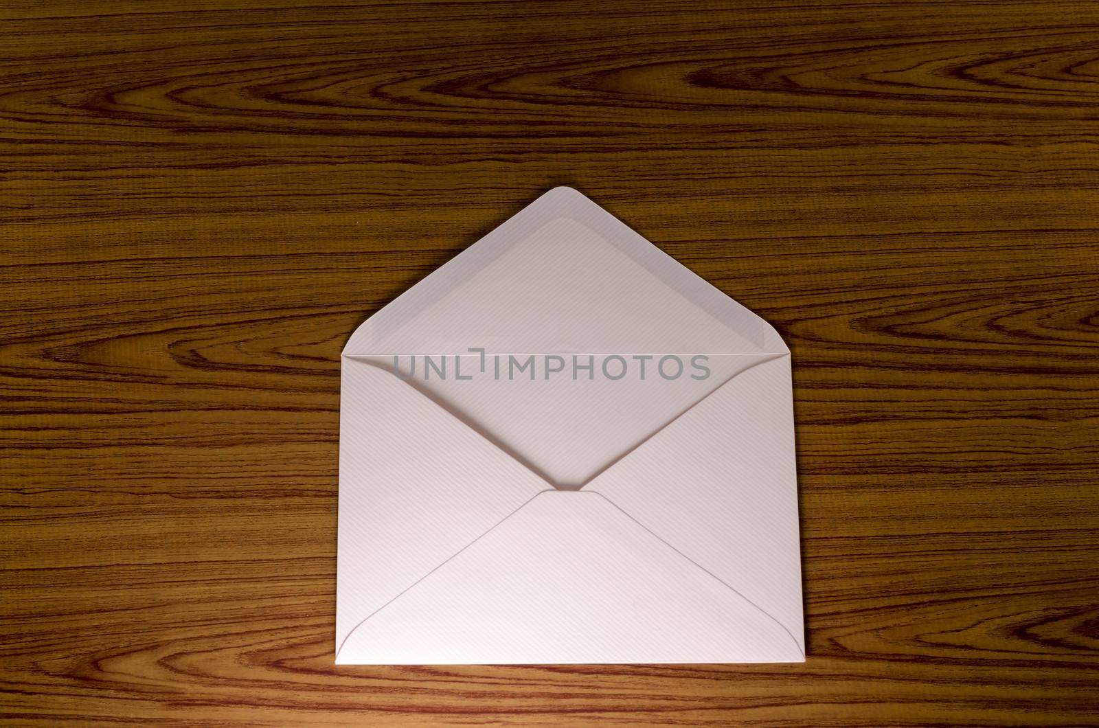 soft pink envelope on wooden background