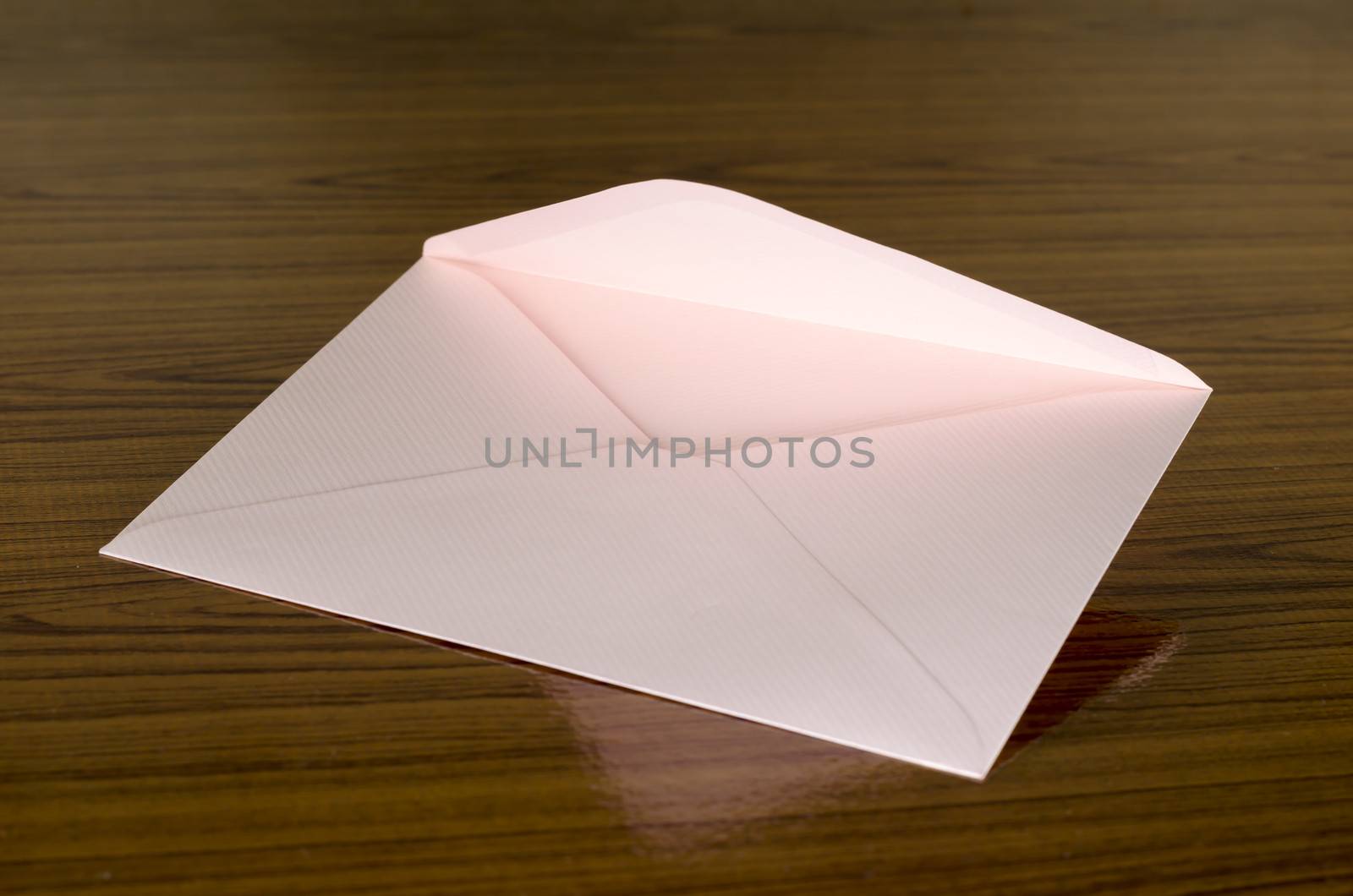 soft pink envelope on wooden background