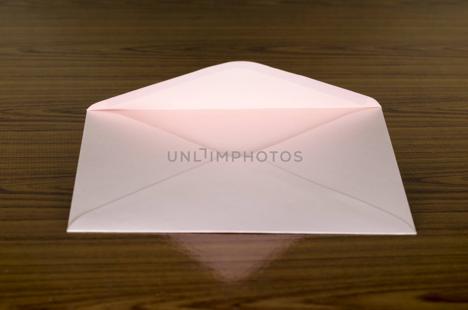 soft pink envelope on wooden background