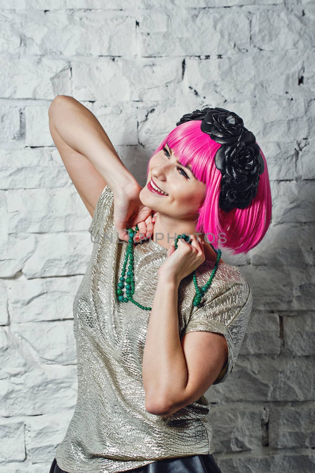 Attractive young girl with rim on head holding beads