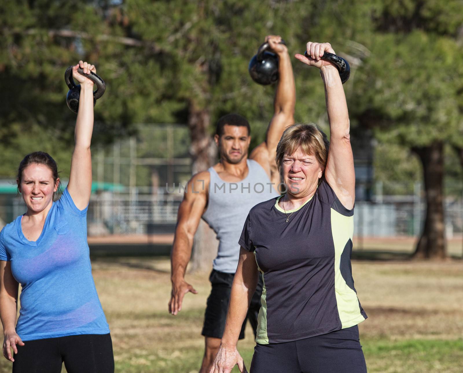 Mature white female exercising with kettle bell weights