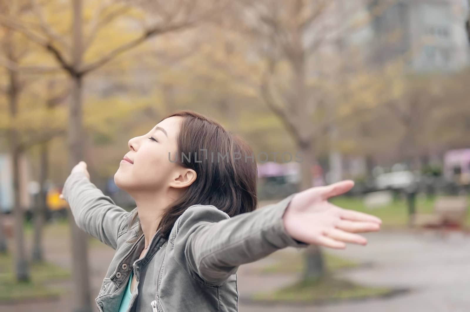 Asian beauty open arms and feel free in the city.