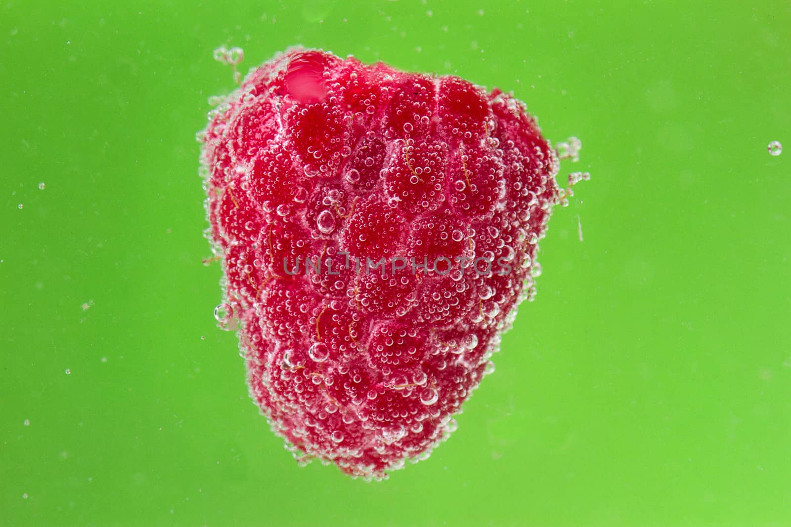 raspberries with bubbles in water