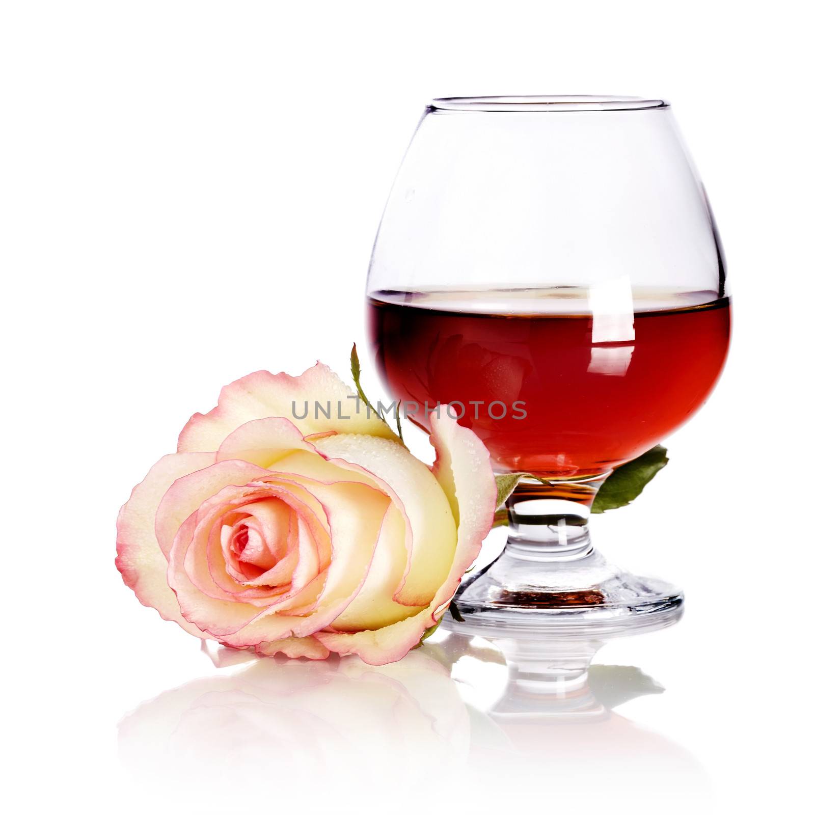 Glass and rose. Alcohol and flower. Glass with drink and a pink rose. Glass with alcohol and rose.