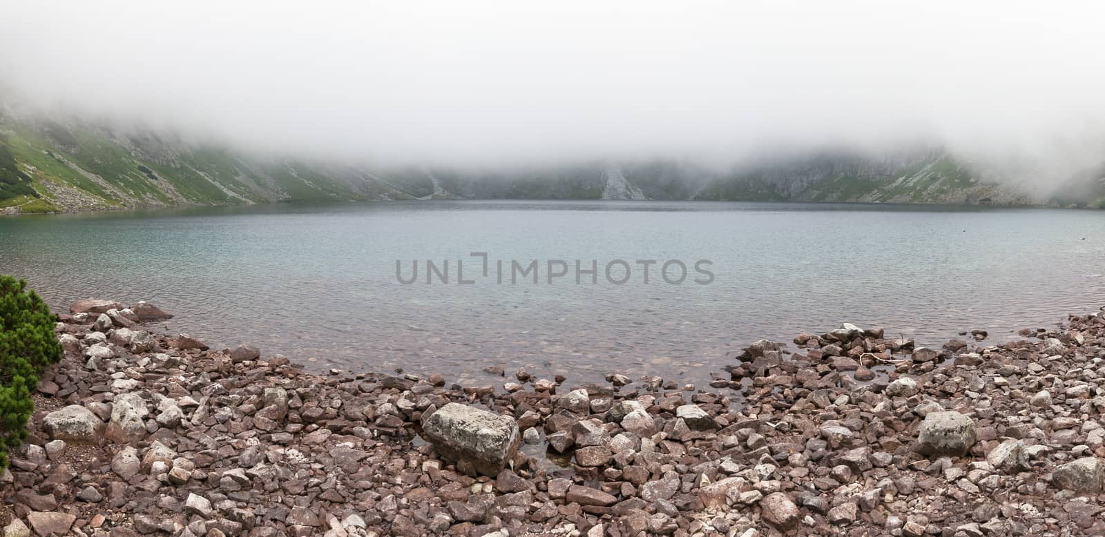 Thick clouds over Black Lake below Mount Rysy in Tatra Mountains, Poland