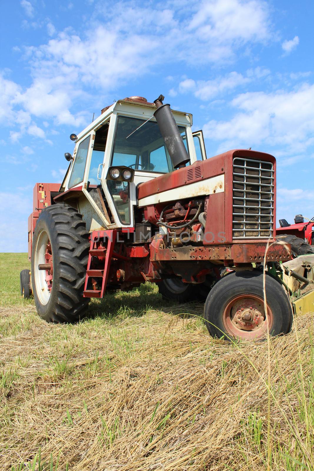 An old farm tractor sitting in a field