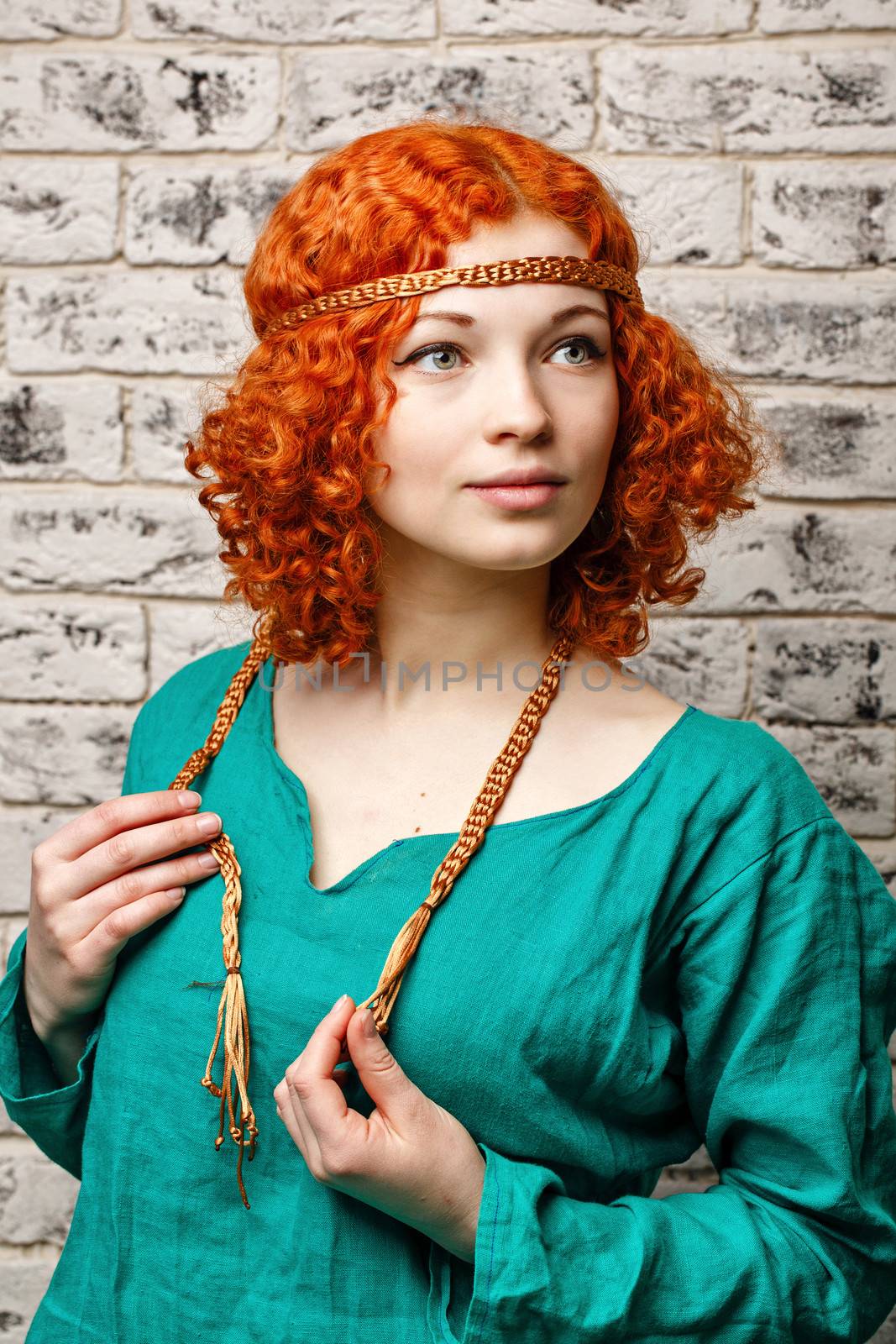 Attractive young girl with red hair in a studio portrait