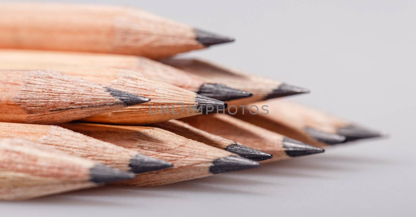 Graphite wooden pencils for sketching shot closeup background