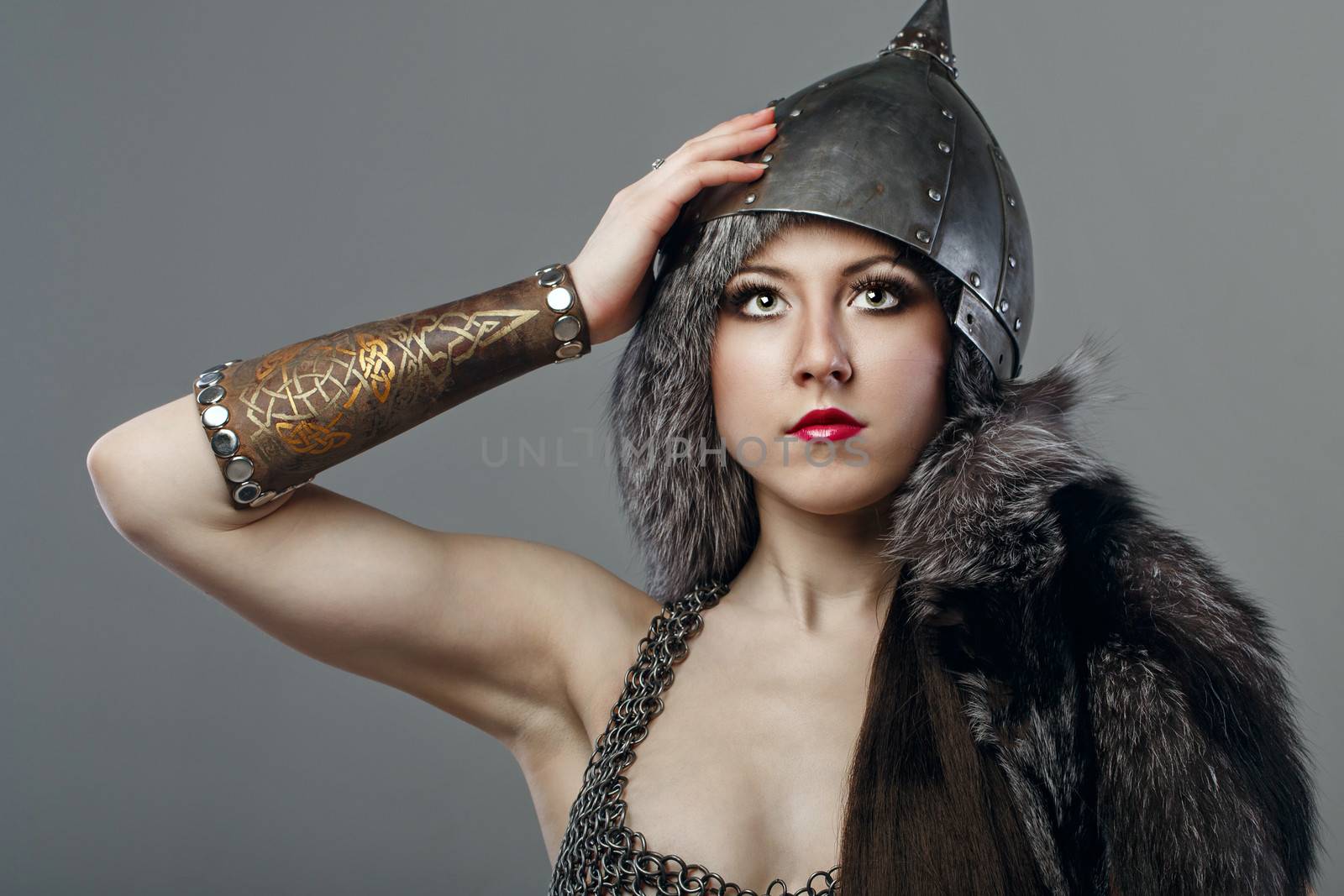 Attractive young girl with historical armor shot in studio