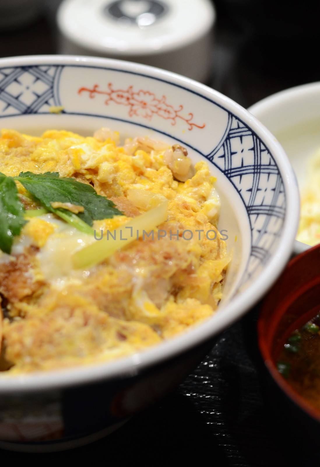 Close up of Katsudon pork cutlet with fried egg on rice  by siraanamwong