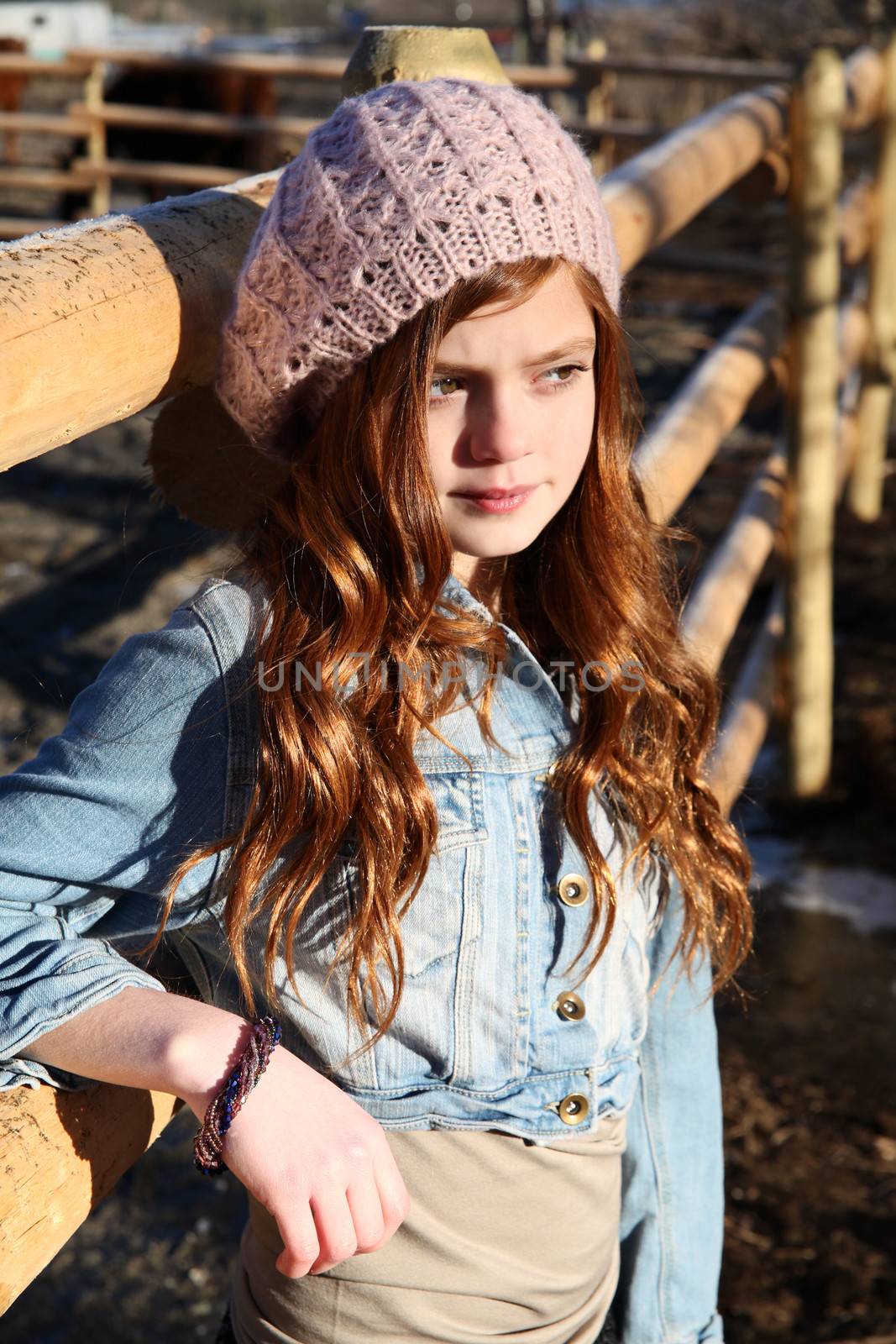 Teen girl outdoors on farm with horses 