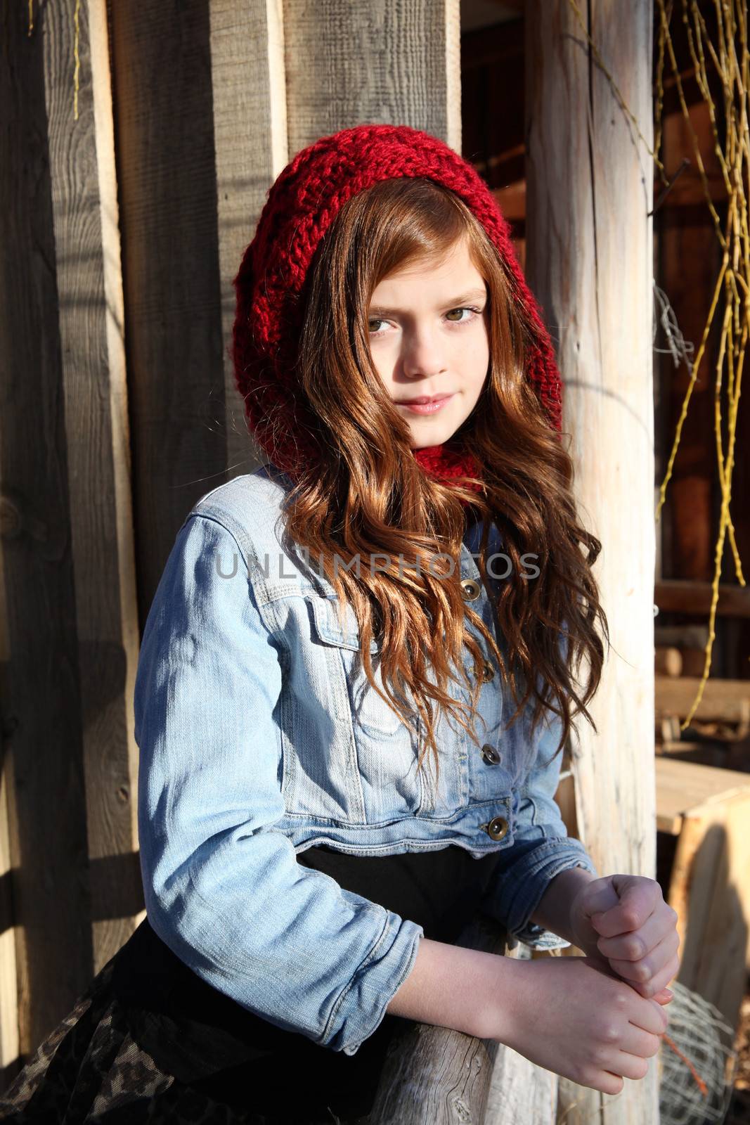 Teen winter girl wearing a red hat 