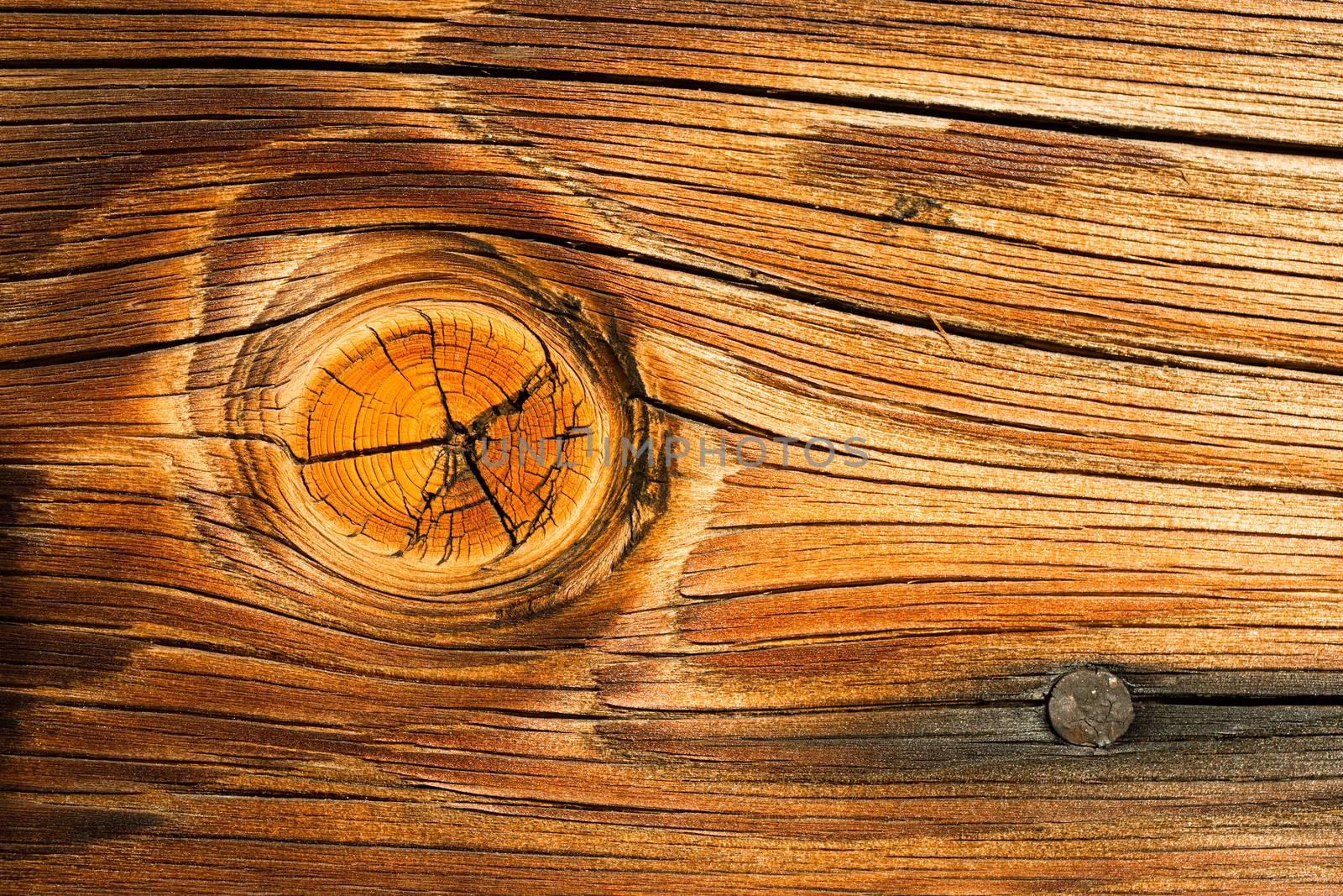 Interesting Orange weather wood plank with a big knot