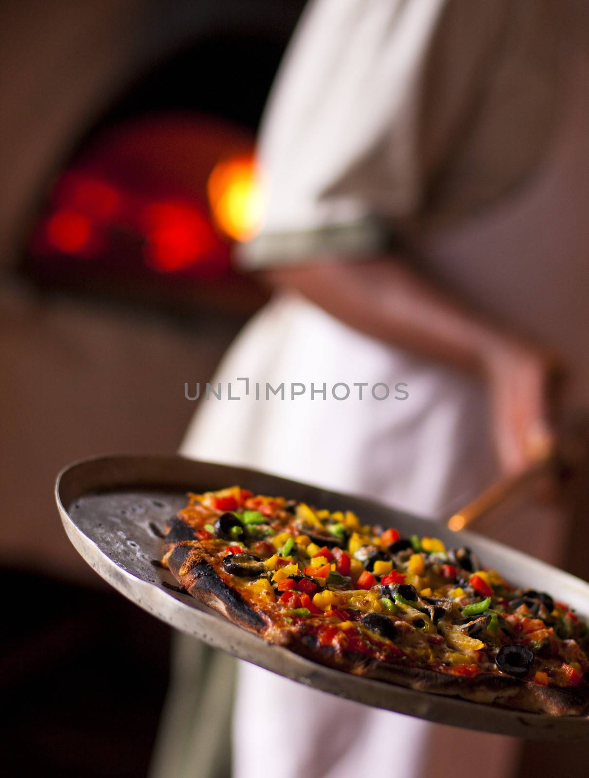 Traditional pizza baked with oven in the background