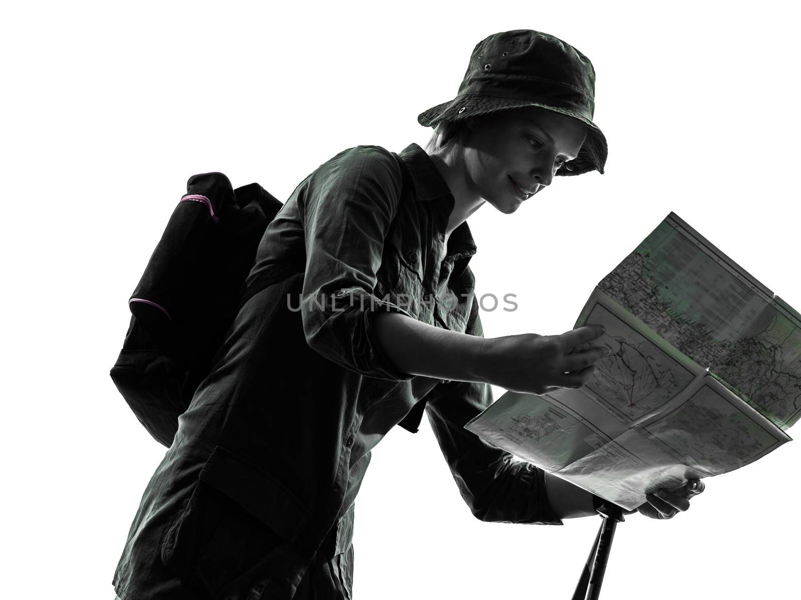 one caucasian woman trekker trekking looking at map in silhouette studio isolated on white background