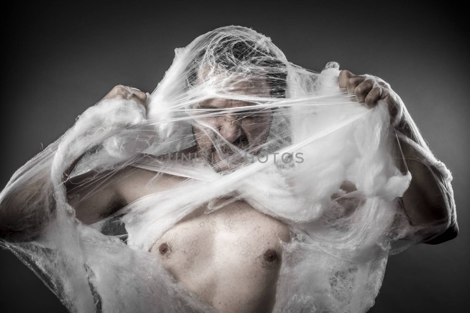 Danger. man tangled in huge white spider web by FernandoCortes