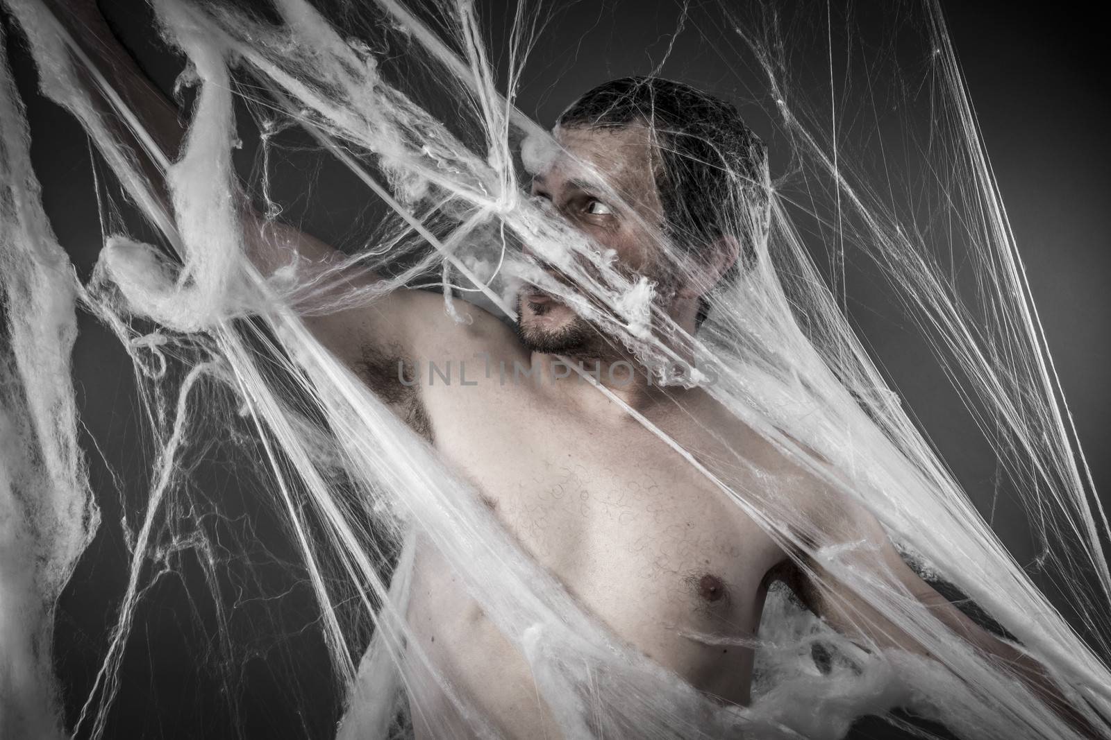 Scary network.man tangled in huge white spider web by FernandoCortes